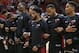Members of the Miami Heat stand locking arms during the singing of the National Anthem before the start of an NBA preseason basketball game against the Charlotte Hornets, Monday, Oct. 9, 2017, in Miami. (AP Photo/Wilfredo Lee)