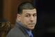 FILE - In this April 14, 2017, file pool photo, former New England Patriots tight end Aaron Hernandez turns to look in the direction of the jury as he reacts to his double murder acquittal after the sixth day of jury deliberations at Suffolk Superior Court in Boston. Massachusetts prosecutors on Friday, June 23, 2017, appealed a court ruling that erased the former NFL star's murder conviction in the 2013 killing of a semi-professional football player. Hernandez's conviction inwas voided after he killed himself in prison. Under a long-held Massachusetts legal principle, courts typically erase the convictions of defendants who die before their direct appeals can be heard. (AP Photo/Stephan Savoia, Pool, File)