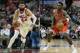 FILe - At left, in a Jan. 2, 2017, file photo, Chicago Bulls forward Nikola Mirotic brings the ball up court against the Charlotte Hornets during the second half of an NBA basketball game in Chicago. At right, in an Oct. 4, 2017, file photo, Chicago Bulls' Bobby Portis (5) handles the ball during a preseason NBA basketball game against the Dallas Mavericks, in Dallas. The Chicago Bulls have suspended forward Bobby Portis for the first eight games for injuring teammate Nikola Mirotic during a fight at practice. Mirotic suffered multiple broken bones in his face as well as a concussion on Tuesday. He will likely need surgery and is out indefinitely. The team announced the suspension on Wednesday, Oct. 18, 2017. (AP Photo/Tony Gutierrez)