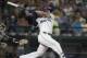 Seattle Mariners' Yonder Alonso follows through on a solo home run off Oakland Athletics starting pitcher Jharel Cotton during the fifth inning of a baseball game Saturday, Sept. 2, 2017, in Seattle. (AP Photo/Stephen Brashear)