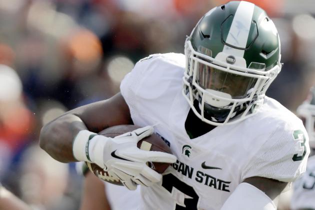 Michigan State running back LJ Scott (3) runs into Illinois' Hardy Nickerson during the first half of an NCAA college football game at Memorial Stadium Saturday, Nov. 5, 2016, in Champaign, Ill. (AP Photo/ Stephen Haas)