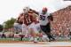AUSTIN, TX - OCTOBER 21: Sam Ehlinger #11 of the Texas Longhorns is forced to scramble under pressure by Taaj Bakari #90 of the Oklahoma State Cowboys in the second quarter at Darrell K Royal-Texas Memorial Stadium on October 21, 2017 in Austin, Texas. (Photo by Tim Warner/Getty Images)