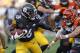 Pittsburgh Steelers running back Le'Veon Bell (26) gets past Cincinnati Bengals defensive end Carl Lawson (58) during the first half of an NFL football game in Pittsburgh, Sunday, Oct. 22, 2017. (AP Photo/Keith Srakocic)