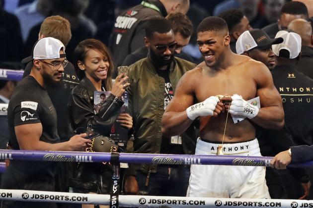 British boxer Anthony Joshua, right, smiles as he celebrates after beating Ukrainian boxer Wladimir Klitschko in a fight for Joshua's IBF and the vacant WBA Super World and IBO heavyweight titles at Wembley stadium in London, Saturday, April 29, 2017. Joshua won with an 11th round stoppage. (AP Photo/Matt Dunham)