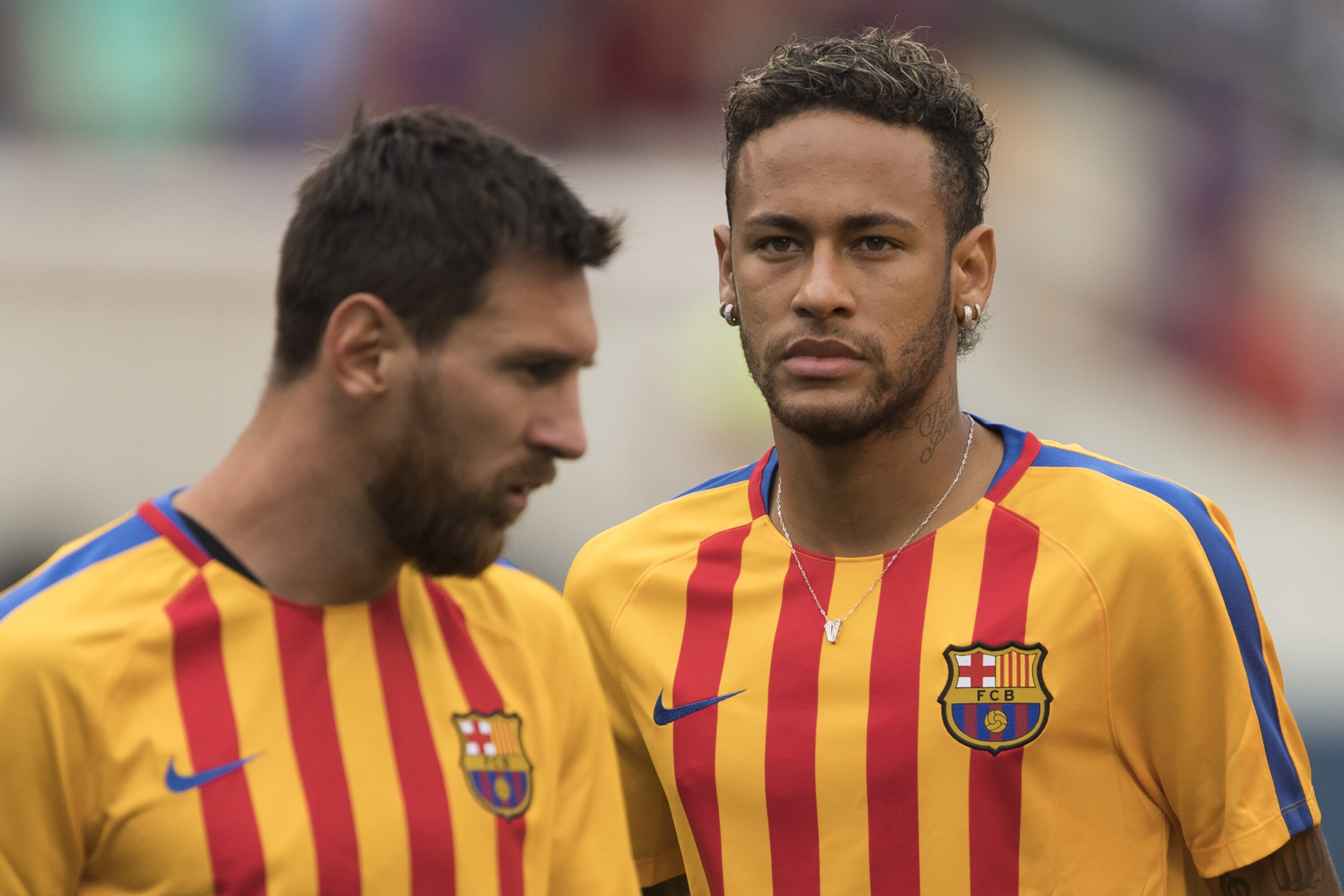 (FILES) This file photo taken on July 22, 2017 shows Neymar (R) and Lionel Messi (L) of FC Barcelona warming up before the International Champions Cup (ICC) match between Juventus FC and FC Barcelona at the Met Life Stadium in East Rutherford, New Jersey. One argument backing Neymar's decision to leave Barca on top of reportedly tripling his wages is to move out of Messi's shadow and compete to become the first Ballon d'Or winner outside of Messi and Ronaldo for a decade. / AFP PHOTO / DON EMMERT (Photo credit should read DON EMMERT/AFP/Getty Images)