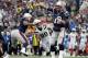 New England Patriots quarterback Tom Brady (12) pbades under pressure from Los Angeles Chargers defensive end Joey Bosa (99) during the first half of an NFL football game, Sunday, Oct. 29, 2017, in Foxborough, Mbad. (AP Photo/Michael Dwyer)