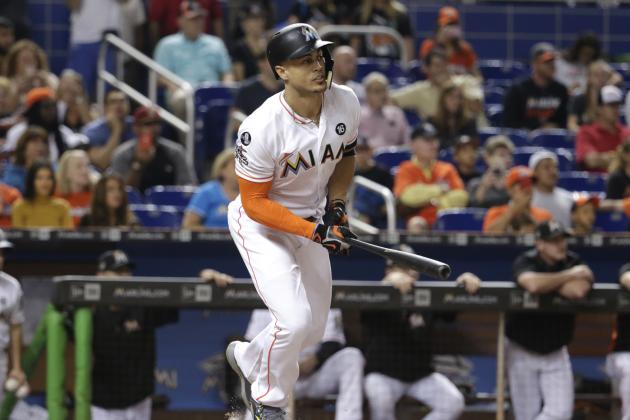 Miami Marlins' Giancarlo Stanton hits a RBI single to score Miguel Rojas during the fifth inning of a baseball game against the Atlanta Braves, Saturday, Sept. 30, 2017, in Miami. (AP Photo/Lynne Sladky)
