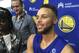 Golden State Warriors Stephen Curry takes questions from the media after NBA basketball practice in Oakland, Calif., Saturday, Sept. 23, 2017. President Donald Trump doubled down on denouncing protests by NFL players and rescinded NBA star Stephen Curry's White House invitation on Saturday, a series of tweets that quickly inflamed football and basketball stars and even prompted LeBron James to call the president a