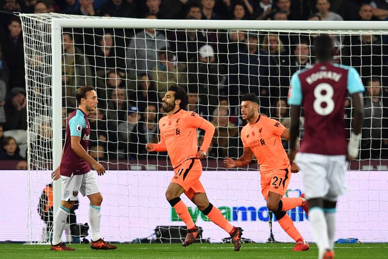 Liverpool's Egyptian midfielder Mohamed Salah (C) celebrates after scoring during the English Premier League football match between West Ham United and Liverpool at The London Stadium, in east London on November 4, 2017. / AFP PHOTO / Ben STANSALL / RESTRICTED TO EDITORIAL USE. No use with unauthorized audio, video, data, fixture lists, club/league logos or 'live' services. Online in-match use limited to 75 images, no video emulation. No use in betting, games or single club/league/player publications. / (Photo credit should read BEN STANSALL/AFP/Getty Images)