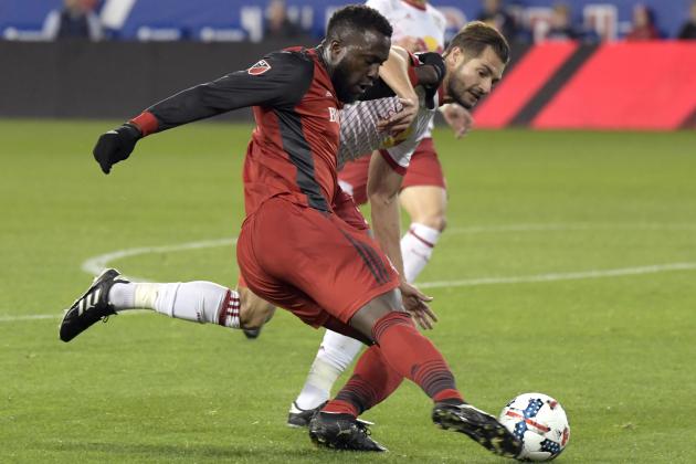 Toronto FC forward Jozy Altidore, left, passes the ball by New York Red Bulls defender Damien Perrinelle, right, during the first half of an MLS Eastern Conference semifinal soccer match Monday, Oct. 30, 2017, in Harrison, N.J. (AP Photo/Bill Kostroun)