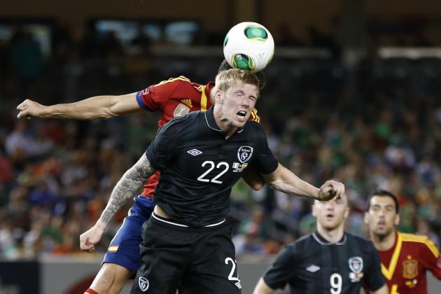 Ireland forward Andy Keogh (22) heads the ball in front of a Spanish defender as teammate Conor Sammon (9) and Spain midfielder Sergio Busquets (16) watch the play in the first half of an international friendly soccer match at Yankee Stadium in New York, Tuesday, June 11, 2013.  (AP Photo/Kathy Willens)