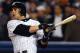 New York Yankees' Aaron Boone watches his game-winning home run off Boston Red Sox pitcher Tim Wakefield in the 11th inning of Game 7 of the American League Championship Series in New York Thursday, Oct. 16, 2003.(AP Photo/Charles Krupa)