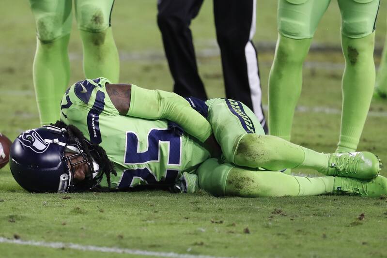 Seattle Seahawks cornerback Richard Sherman (25) lies on the turf after tackling Arizona Cardinals wide receiver John Brown during the second half of an NFL football game, Thursday, Nov. 9, 2017, in Glendale, Ariz. (AP Photo/Rick Scuteri)