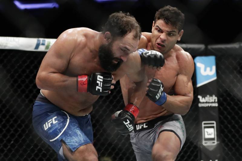 Paulo Costa, of Brazil, punches Johny Hendricks, left, during a middleweight mixed martial arts bout at UFC 217 on Saturday, Nov. 4, 2017, in New York. Costa won the fight. (AP Photo/Frank Franklin II)