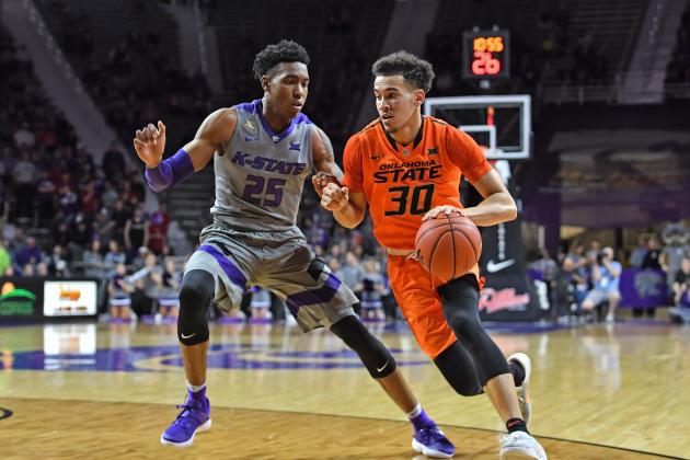 MANHATTAN, KS - FEBRUARY 22:  Guard Jeffrey Carroll #30 of the Oklahoma State Cowboys drives against guard Wesley Iwundu #25 of the Kansas State Wildcats during the first half on February 22, 2017 at Bramlage Coliseum in Manhattan, Kansas.  Oklahoma State defeated Kansas State 80-68. (Photo by Peter G. Aiken/Getty Images)