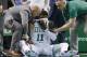 Team personnel assist Boston Celtics' Kyrie Irving (11) after he was injured during the first quarter of an NBA basketball game against the Charlotte Hornets in Boston, Friday, Nov. 10, 2017. Irving took an elbow to the face and left the game. (AP Photo/Michael Dwyer)
