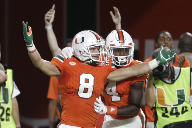 Miami wide receiver Braxton Berrios (8) celebrates with wide receiver Jeff Thomas (4) after scoring a touchdown during the first half of an NCAA college football game against Notre Dame, Saturday, Nov. 11, 2017, in Miami Gardens, Fla. (AP Photo/Lynne Sladky)