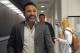 Ten-time boxing title holder and boxing promoter Oscar de la Hoya walks down a hallway prior to an interview with one of his boxers, eight-time title holder Saul