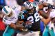CHARLOTTE, NC - NOVEMBER 13: T.J. McDonald #22 of the Miami Dolphins tackles Jonathan Stewart #28 of the Carolina Panthers during their game at Bank of America Stadium on November 13, 2017 in Charlotte, North Carolina. (Photo by Grant Halverson/Getty Images)