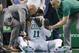 Team personnel assist Boston Celtics' Kyrie Irving (11) after he was injured during the first quarter of an NBA basketball game against the Charlotte Hornets in Boston, Friday, Nov. 10, 2017. Irving took an elbow to the face and left the game. (AP Photo/Michael Dwyer)