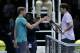 David Goffin of Belgium, left, shakes hands with Roger Federer of Switzerland after Goffin won their ATP World Tour Finals semifinal tennis match at the O2 Arena in London, Saturday Nov. 18, 2017. (AP Photo/Tim Ireland)