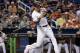 Miami Marlins' Giancarlo Stanton hits a single during the third inning of a baseball game against the Atlanta Braves, Sunday, Oct. 1, 2017, in Miami. (AP Photo/Lynne Sladky)