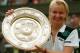 FILE - In this July 4, 1998 file photo, Jana Novotna, of the Czech Republic, displays the women's singles trophy after her victory over France's Nathalie Tauziat in the final on Wimbledon's Centre Court. The WTA says the 1998 Wimbledon champion Jana Novotna of the Czech Republic has died. In a Monday, Nov. 20, 2017 statement, the WTA say Novotna died after battling a cancer on Sunday, Nov. 19. She was 49. (AP Photo/Dave Caulkin, File )