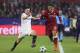 Liverpool's Roberto Firmino, right, runs with the ball past Sevilla's Pablo Sarabia during a Champions League group E soccer match between Sevilla and Liverpool, at the Ramon Sanchez Pizjuan stadium in Seville, Spain, Tuesday, Nov. 21, 2017. (AP Photo/Miguel Morenatti)