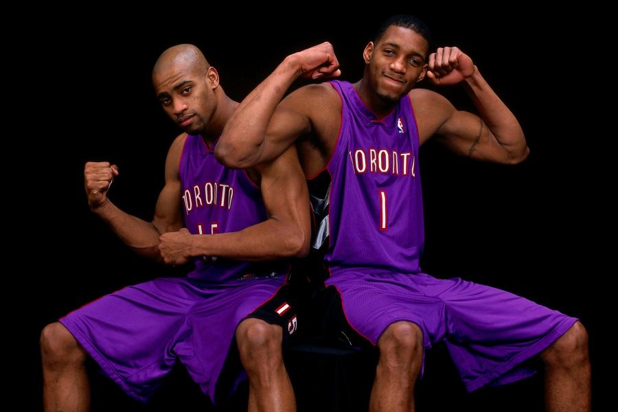 Toronto Raptors' Vince Carter(right) hugs his cousin Tracy McGrady