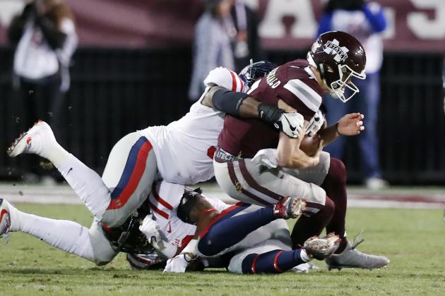 Mississippi State quarterback Nick Fitzgerald, right, is tackled by Mississippi defenders and is injured during the first half of an NCAA college football game in Starkville, Miss., Thursday, Nov. 23, 2017. Fitzgerald left the field on a cart. (AP Photo/Rogelio V. Solis)