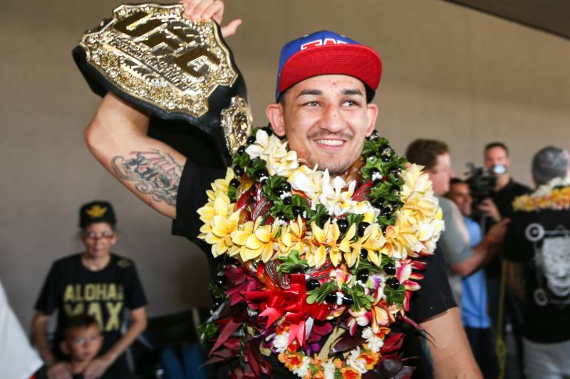 HONOLULU, HI - JUNE 05: Max Holloway raises his UFC Championship belt as he greets his fans upon his arrival at the Daniel K. Inouye International Airport on June 5, 2017 in Honolulu, Hawaii. Holloway became the the undisputed UFC Featherweight Champion after beating Jose Aldo. (Photo by Zuffa LLC/Zuffa LLC via Getty Images)