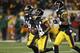 Pittsburgh Steelers wide receiver Antonio Brown (84) comes off the field with running back Le'Veon Bell (26) and fellow wide receiver Martavis Bryant (10) after scoting a touchdown in an NFL football game against the Green Bay Packers, Sunday, Nov. 26, 2017, in Pittsburgh. (AP Photo/Keith Srakocic)