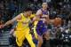 Denver Nuggets guard Jamal Murray, left, loses his footing as he tries to stop Los Angeles Lakers guard Lonzo Ball as he drives upcourt in the first half of an NBA basketball game Saturday, Dec. 2, 2017, in Denver. (AP Photo/David Zalubowski)
