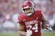 Oklahoma running back Rodney Anderson (24) carries in the second quarter of an NCAA college football game against West Virginia in Norman, Okla., Saturday, Nov. 25, 2017. (AP Photo/Sue Ogrocki)