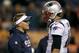 New England Patriots offensive coordinator Josh McDaniels talks with Tom Brady prior to an NFL football game against the Denver Broncos, Sunday, Nov. 12, 2017, in Denver. (AP Photo/David Zalubowski)