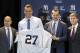 Yankees General Manager Brian Cashman, left, stands next to new Yankee Giancarlo Stanton, center, and his new jersey with Yankee Manager Aaron Boone, right middle, and Yankee Owner Hal Steinbrenner, right, during the Major League Baseball winter meetings in Orlando, Fla., Monday, Dec. 11, 2017. (AP Photo/Willie J. Allen Jr.)