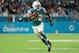 MIAMI GARDENS, FL - DECEMBER 11: Kenyan Drake #32 of the Miami Dolphins carries the ball in the third quarter against the New England Patriots at Hard Rock Stadium on December 11, 2017 in Miami Gardens, Florida. (Photo by Mike Ehrmann/Getty Images)