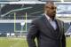 FILE - In this Sept. 19, 2013, file photo, former Philadelphia Eagles quarterback Donovan McNabb pauses during a television interview before an NFL football game against the Kansas City Chiefs, in Philadelphia. McNabb will serve 18 days in an Arizona jail after he pleaded guilty to a non-extreme DUI. McNabb was stopped by police in the Phoenix suburb of Gilbert on June 28, 2015, while driving impaired. (AP Photo/Julio Cortez, File)