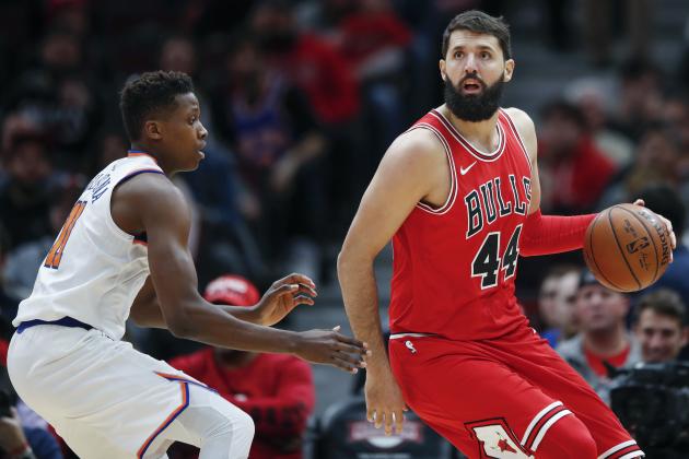 Chicago Bulls forward Nikola Mirotic (44) is defended by New York Knicks guard Frank Ntilikina (11) during the first half of an NBA basketball game, Saturday, Dec. 9, 2017, in Chicago. (AP Photo/Kamil Krzaczynski)