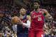 Oklahoma City Thunder's Russell Westbrook, left, drives to the basket past Philadelphia 76ers' Joel Embiid, right, of Cameroon, during the first half of an NBA basketball game, Friday, Dec. 15, 2017, in Philadelphia. (AP Photo/Chris Szagola)