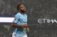 Manchester City's English midfielder Raheem Sterling celebrates after scoring their third goal during the English Premier League football match between Manchester City and Tottenham Hotspur at the Etihad Stadium in Manchester, north west England, on December 16, 2017. / AFP PHOTO / PAUL ELLIS / RESTRICTED TO EDITORIAL USE. No use with unauthorized audio, video, data, fixture lists, club/league logos or 'live' services. Online in-match use limited to 75 images, no video emulation. No use in betting, games or single club/league/player publications. / (Photo credit should read PAUL ELLIS/AFP/Getty Images)