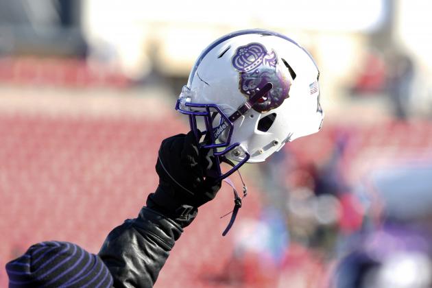 A member of the staff holds up a James Madison helmet during the FCS championship NCAA college football game against Youngstown State on Saturday, Jan. 7, 2017, in Frisco, Texas. (AP Photo/Sarah Warnock)