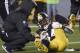 Pittsburgh Steelers wide receiver Antonio Brown (84) is helped by a trainer after being injured during the first half of an NFL football game against the New England Patriots in Pittsburgh, Sunday, Dec. 17, 2017. (AP Photo/Don Wright)