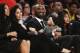 Former Los Angeles Laker Kobe Bryant watches a tribute video with his family during an NBA basketball game between the Los Angeles Lakers and the Golden State Warriors in Los Angeles, Monday, Dec. 18, 2017. The Lakers retired Bryant's No. 8 and No. 24 jersey during a halftime ceremony. (AP Photo/Chris Carlson)