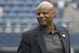NFL Hall of Fame quarterback Warren Moon stands on the field before an NFL football game between the Houston Texans and the Seattle Seahawks, Sunday, Oct. 29, 2017, in Seattle. (AP Photo/Elaine Thompson)