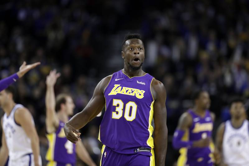 Los Angeles Lakers forward Julius Randle reacts after making a 3-point basket against the Golden State Warriors during the second half of an NBA basketball game Friday, Dec. 22, 2017, in Oakland, Calif. (AP Photo/Marcio Jose Sanchez)
