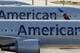 FILE - In this Monday, Nov. 6, 2017, file photo, a pair of American Airlines jets are parked on the airport apron at Miami International Airport in Miami. A scheduling glitch has left American scrambling to find pilots to operate thousands of flights over the busy Christmas holiday period. American said Wednesday, Nov. 29, 2017, it expects to avoid canceling flights by paying overtime and using reserve pilots. (AP Photo/Wilfredo Lee, File)