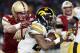 Boston College linebacker Kevin Bletzer (49) prepares to tackle Iowa running back Akrum Wadley (25) who runs with the ball during the first quarter of the Pinstripe Bowl NCAA college football game, Wednesday, Dec. 27, 2017, in New York. (AP Photo/Kathy Willens)