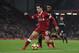 Liverpool's Brazilian midfielder Philippe Coutinho (L) takes on Swansea City's Dutch midfielder Leroy Fer (R) during the English Premier League football match between Liverpool and Swansea City at Anfield in Liverpool, north west England on December 26, 2017. / AFP PHOTO / PAUL ELLIS / RESTRICTED TO EDITORIAL USE. No use with unauthorized audio, video, data, fixture lists, club/league logos or 'live' services. Online in-match use limited to 75 images, no video emulation. No use in betting, games or single club/league/player publications. / (Photo credit should read PAUL ELLIS/AFP/Getty Images)