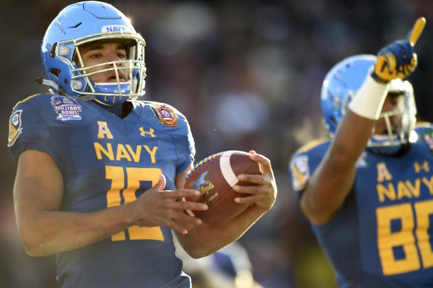 Navy's quarterback Malcolm Perry scores a touchdown against Virginia in the first half of the Military Bowl NCAA college football game, Thursday, Dec. 28, 2017, in Annapolis, Md. (AP Photo/Gail Burton)